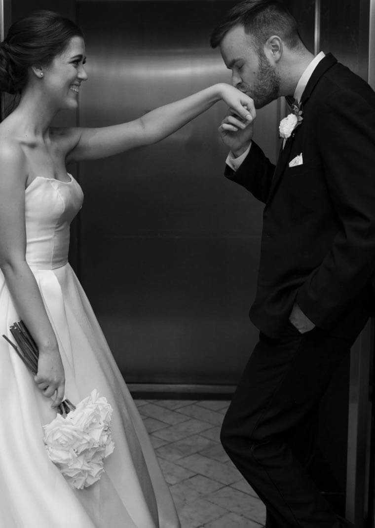 Сouple wearing a white gown and a black suit (black and white photo)