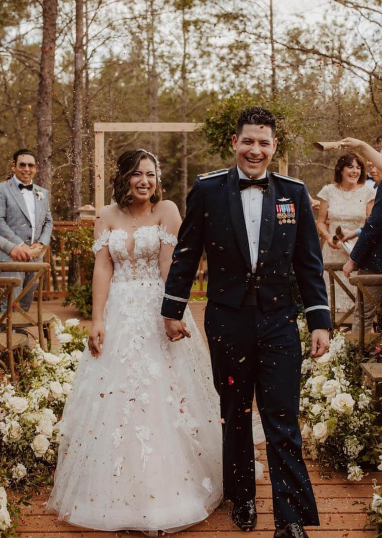 Сouple wearing a white gown and a black suit with friends